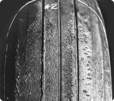 An oval-shaped area in the tread similar to a skid, but where rubber shows burning due to hydroplaning during landing usually caused by wet or ice-covered runways.