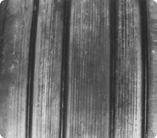 Some retreads have reinforcing cords wound into the tread which become visible as the tire wears.